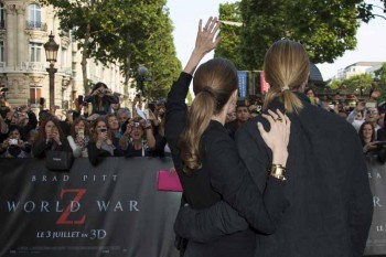 Angelina Jolie and Brad Pitt both sporting straight hair.